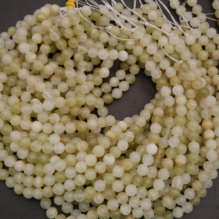 Close-up of a string of light green beads on a dark background