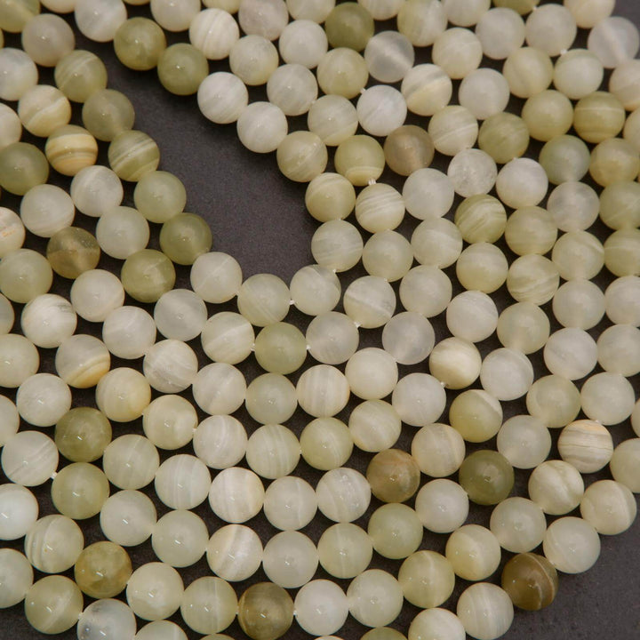 Close-up of light-colored beads on a dark background