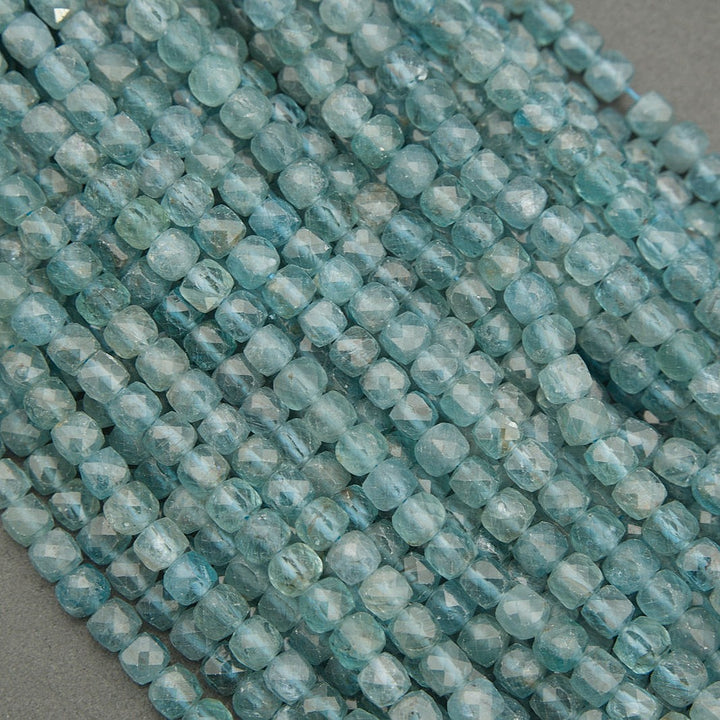 Close-up of blue faceted beads on a gray background