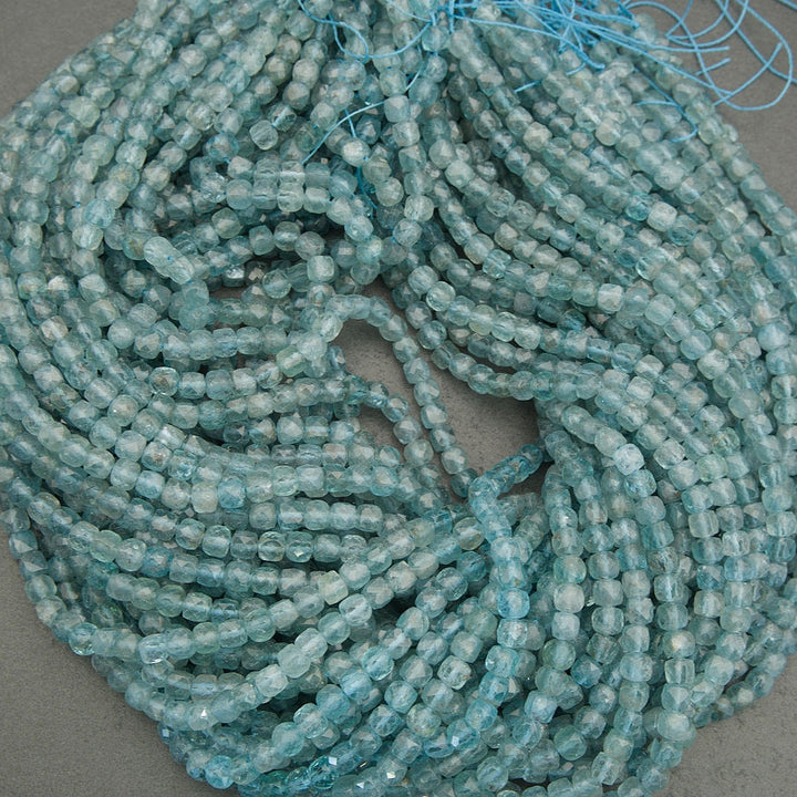 String of light blue beads on a gray background