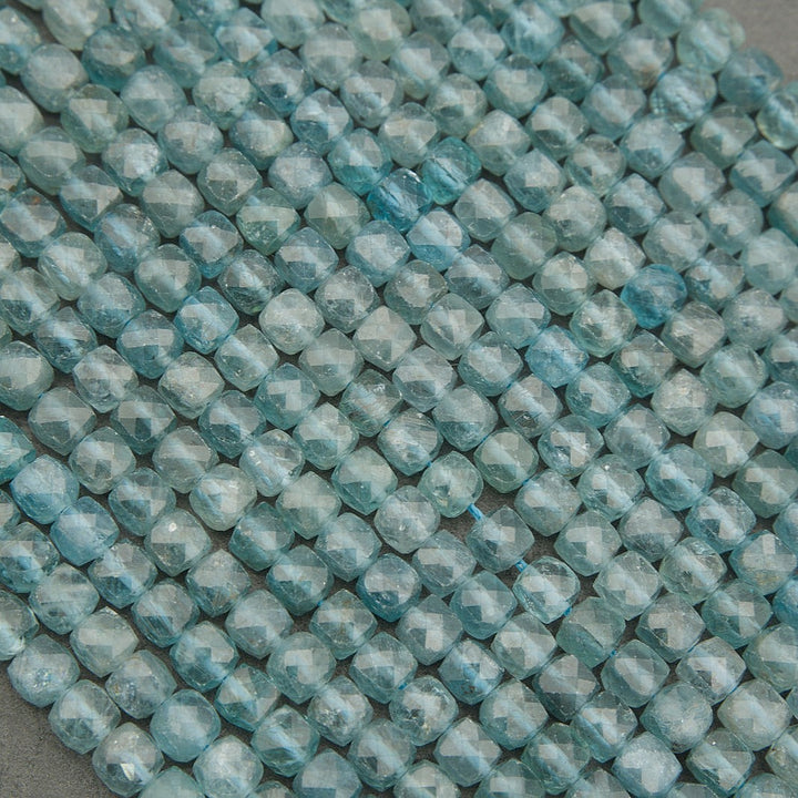 Close-up of light blue faceted beads on a gray background