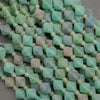 Close-up of green square beads on a gray surface