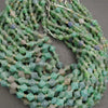 Green bead necklace on a gray background