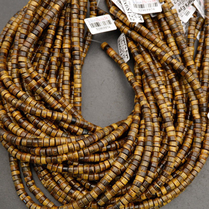 Detailed view of tiger’s eye disc beads with chatoyant striping in brown and honey colors.