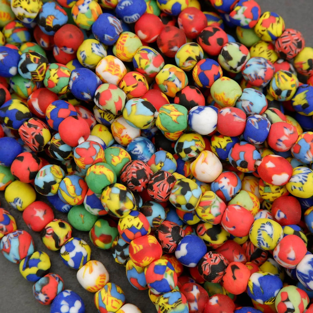Colorful beads with various patterns and designs on a gray surface
