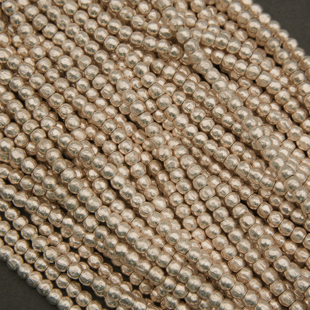 Close-up of silver beads on a dark background
