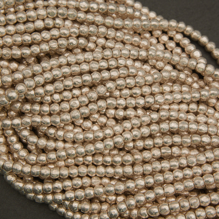 Close-up of a string of silver beads on a dark background