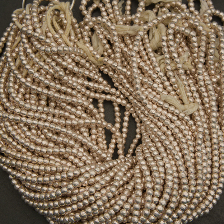 Close-up of a coiled string of pearls on a dark background