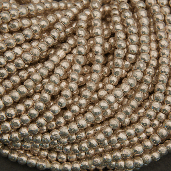 Close-up of a string of metallic beads.