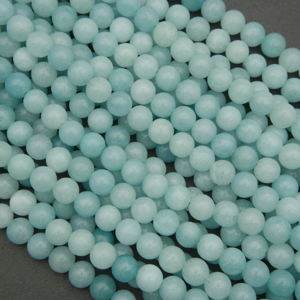 Close-up of light blue beads on a dark background