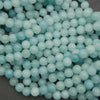 Close-up of light blue beads on a dark background