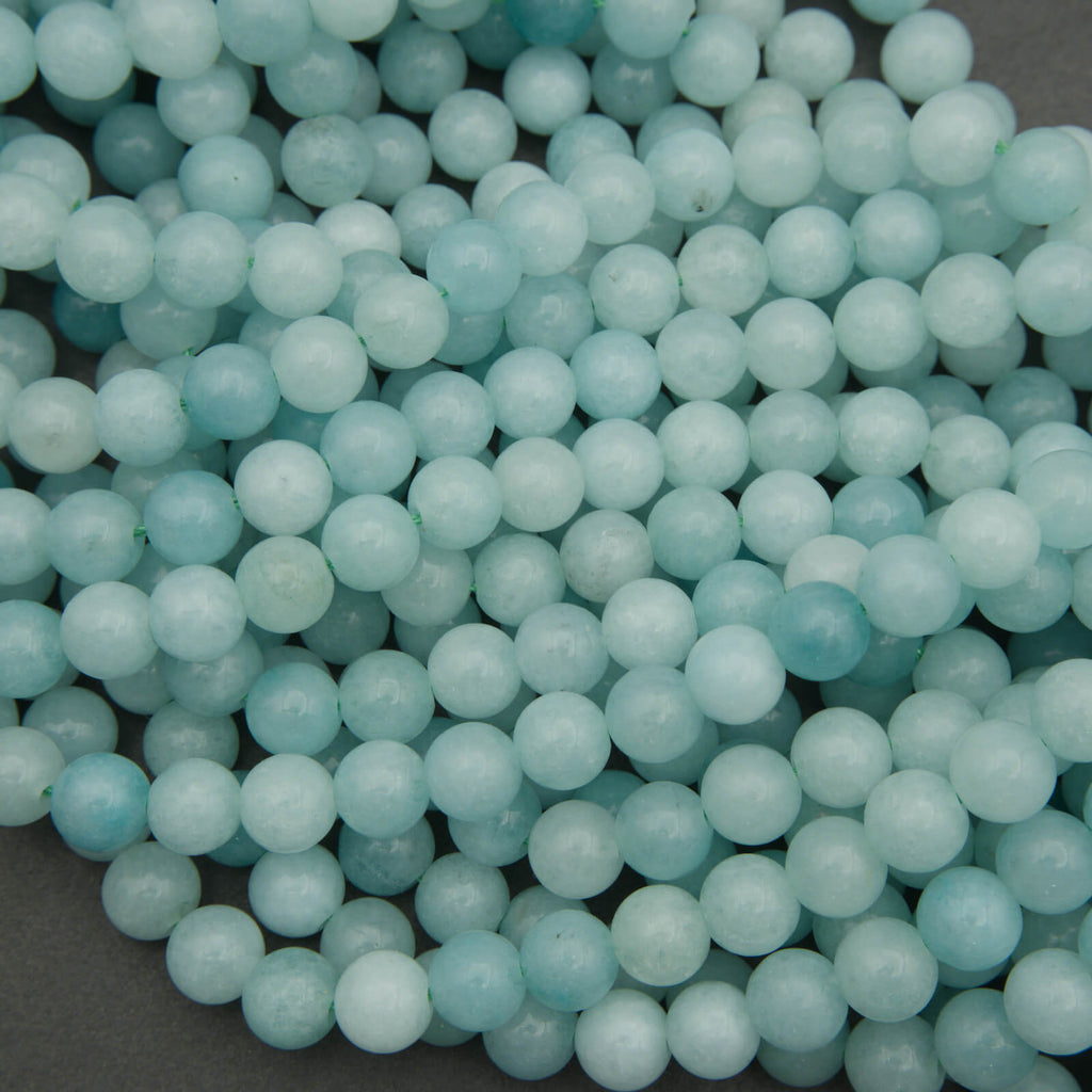 Close-up of light blue beads on a dark background