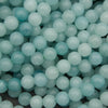 Close-up of light blue beads on a dark background