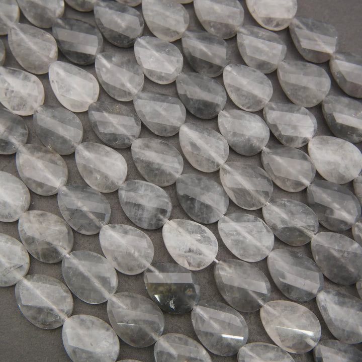 Cloudy clear twisted oval beads.