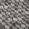 Cloudy clear twisted oval beads.