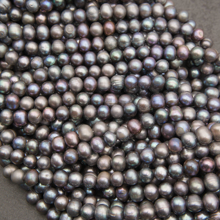 Close-up of peacock freshwater pearl strands in silvery gray with blue, purple and bronze overtones