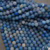 Strands of matte round dyed blue aventurine beads with a Tejas Beads size tag