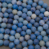 Close-up of matte blue aventurine beads with a soft frosted surface in denim and cobalt blue