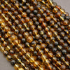 Close-up of a string of black and gold beads on a gray background