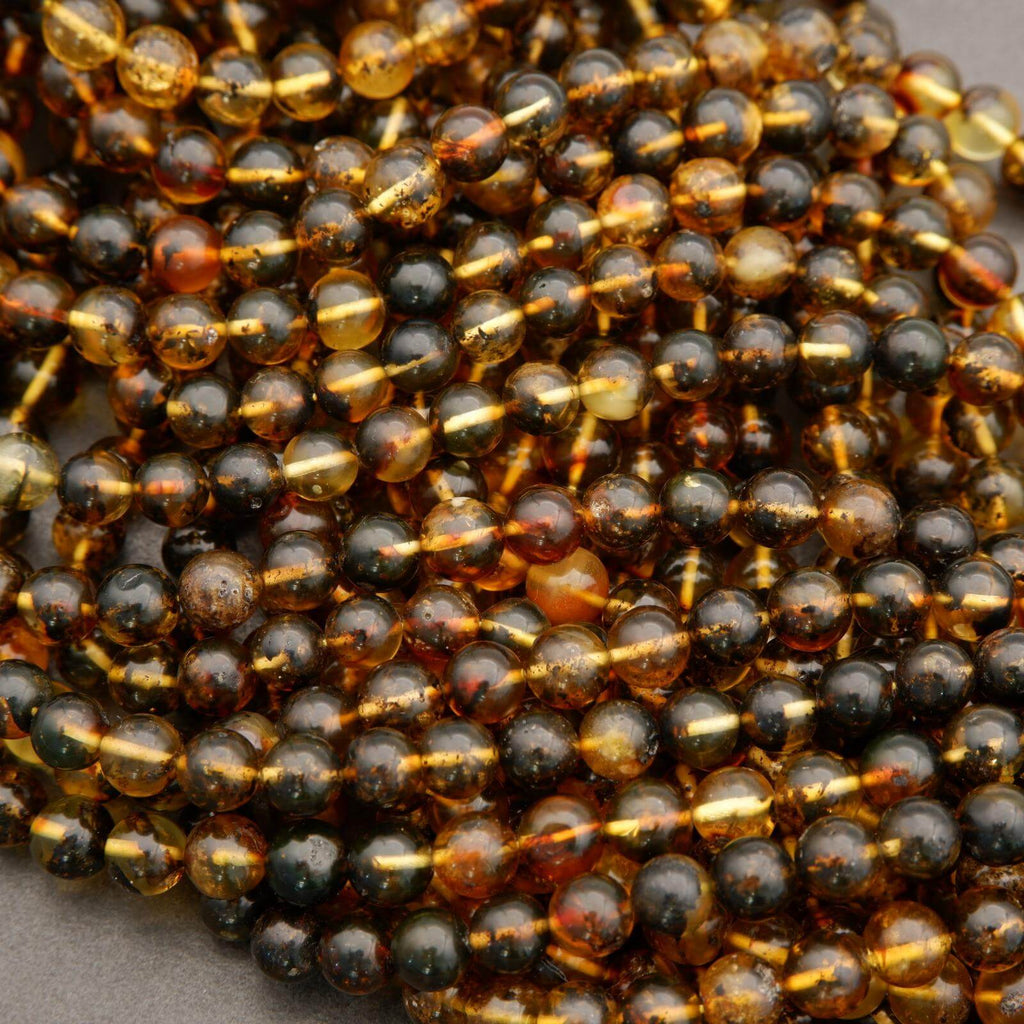Close-up of a string of black and gold beads on a gray background