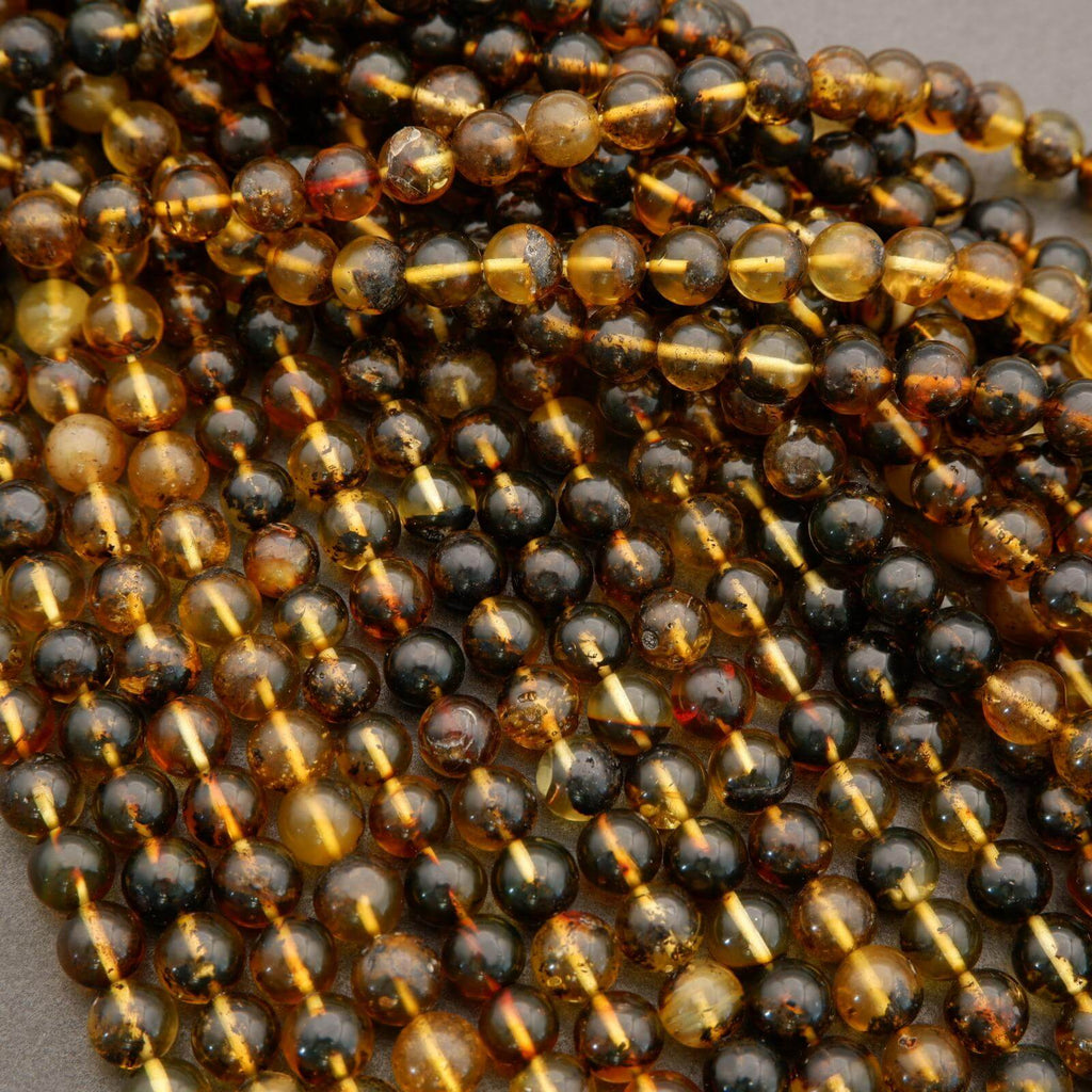 Close-up of amber and black beads on a string