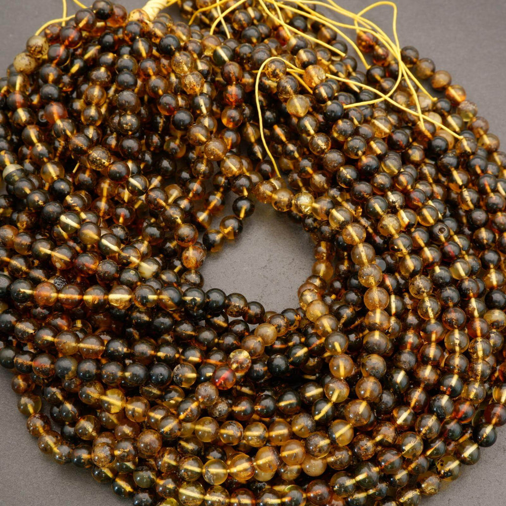 Close-up of a string of black and gold beads on a gray background