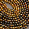 Close-up of amber and black beads on a string