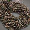 Multicolored heishi beads on a gray surface