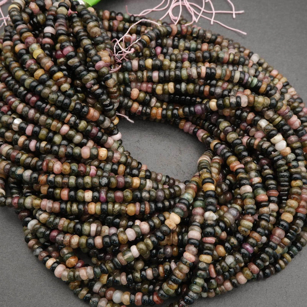 Multicolored heishi beads on a gray surface