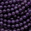 Close-up of purple beads on a dark background