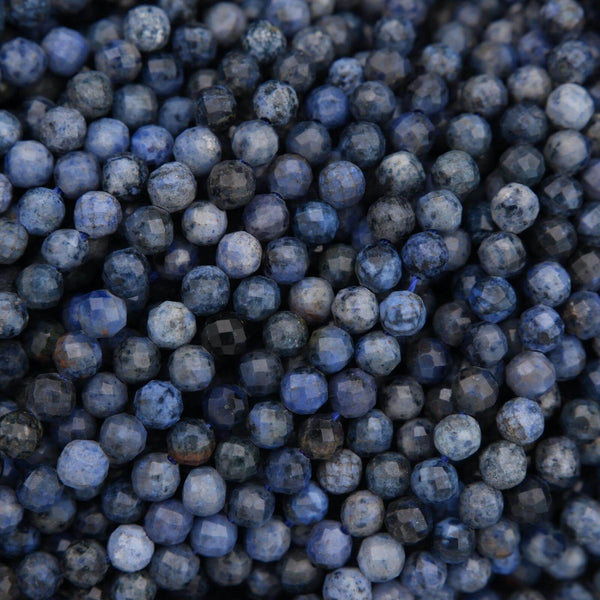 Close-up of blue marbles with a dark background