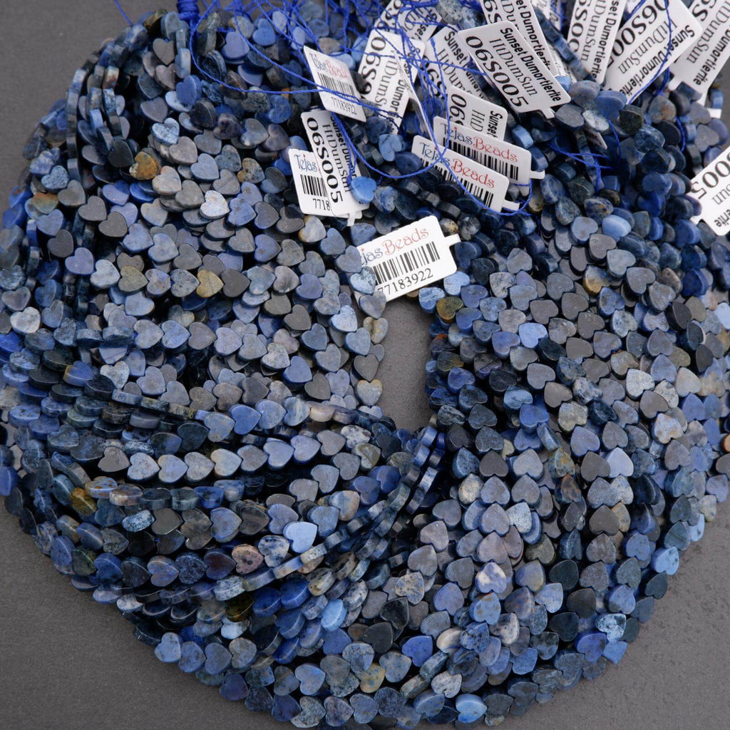 Blue heart-shaped beads with tags on a gray background