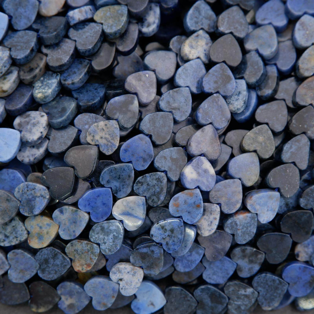 Close-up of heart-shaped stones in various shades of blue and gray.
