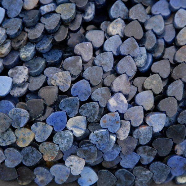 Close-up of heart-shaped stones in various shades of blue and gray.