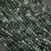 Close-up of green and white beads on a dark background