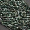 Close-up of green and white beads on a dark surface
