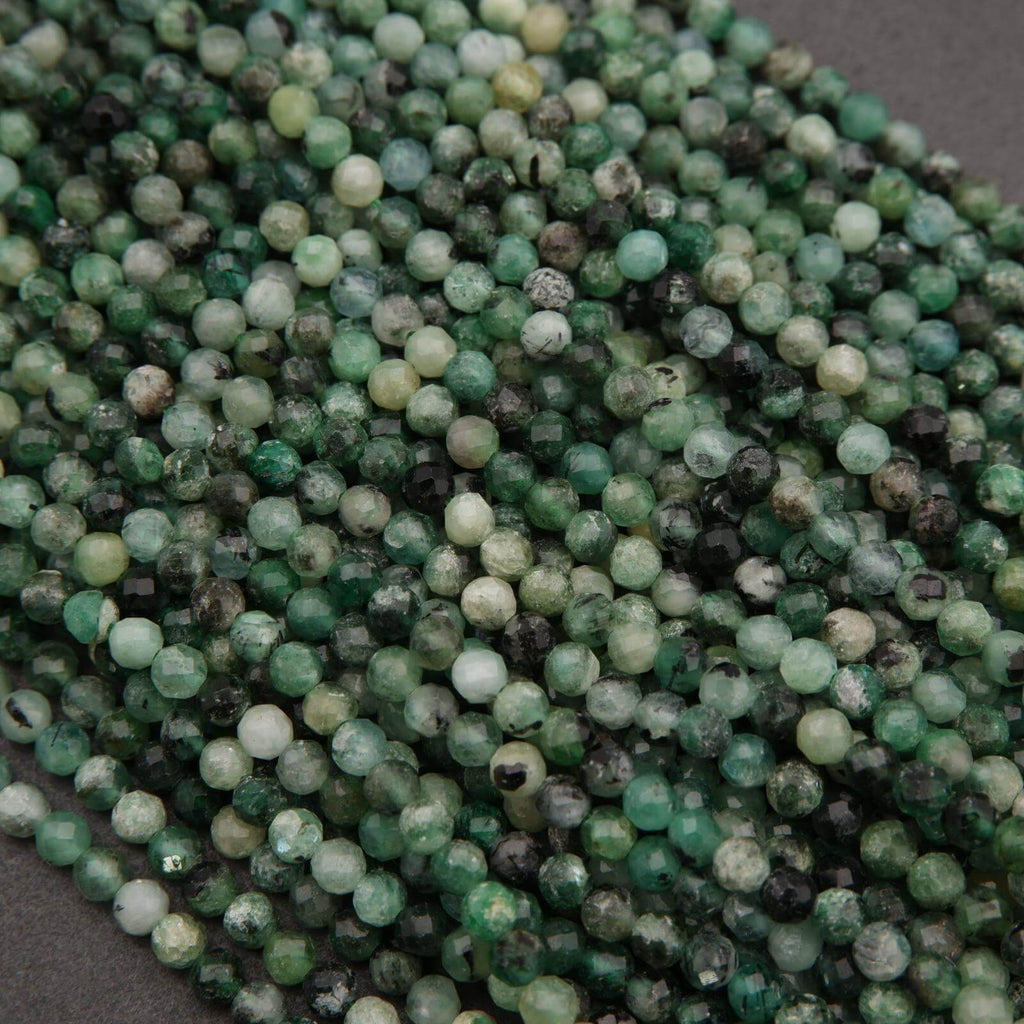 Close-up of green and black beads on a dark surface