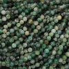 Close-up of green and black beads on a string