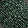 Green faceted round beads with a mix of emerald green hues.
