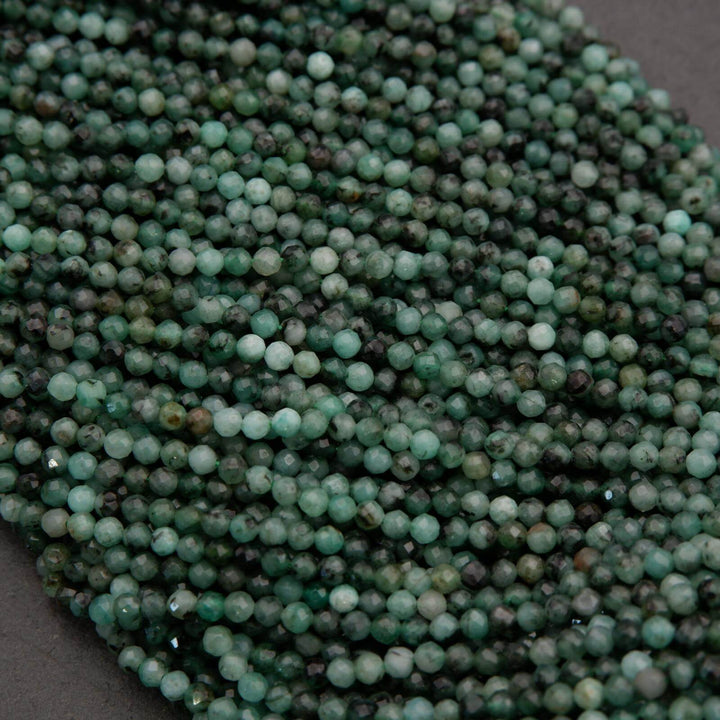 Green faceted round beads with a mix of emerald green hues.