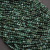 Green faceted round beads with a mix of emerald green hues.