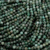 Green faceted round beads with a mix of emerald green hues.