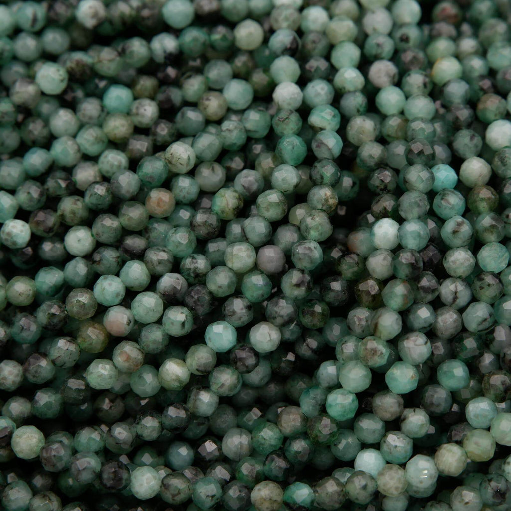 Green faceted round beads with a mix of emerald green hues.