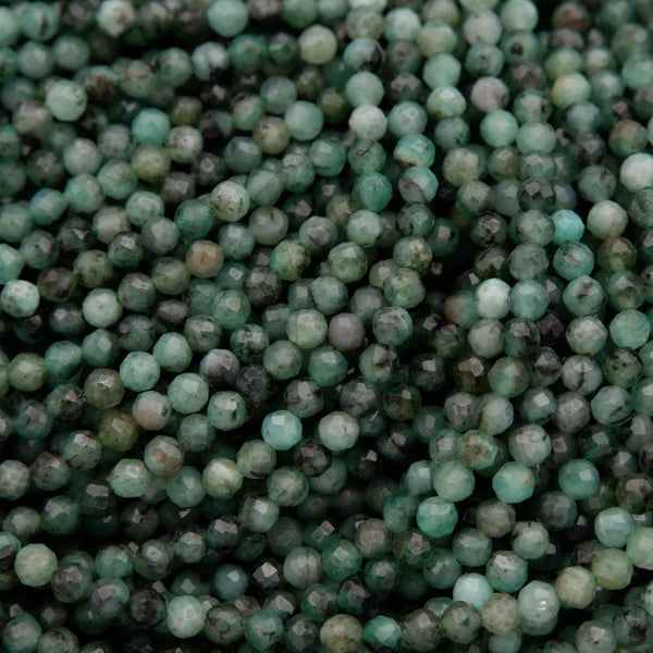 Green faceted round beads with a mix of emerald green hues.
