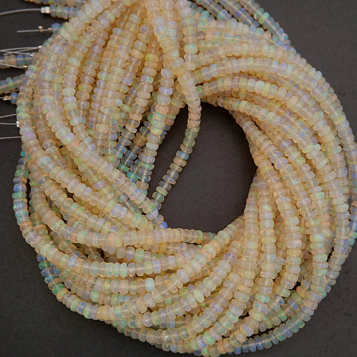 Close-up of a coiled string of small, light-colored beads on a dark background