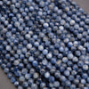 Close-up of blue faceted beads on a gray surface