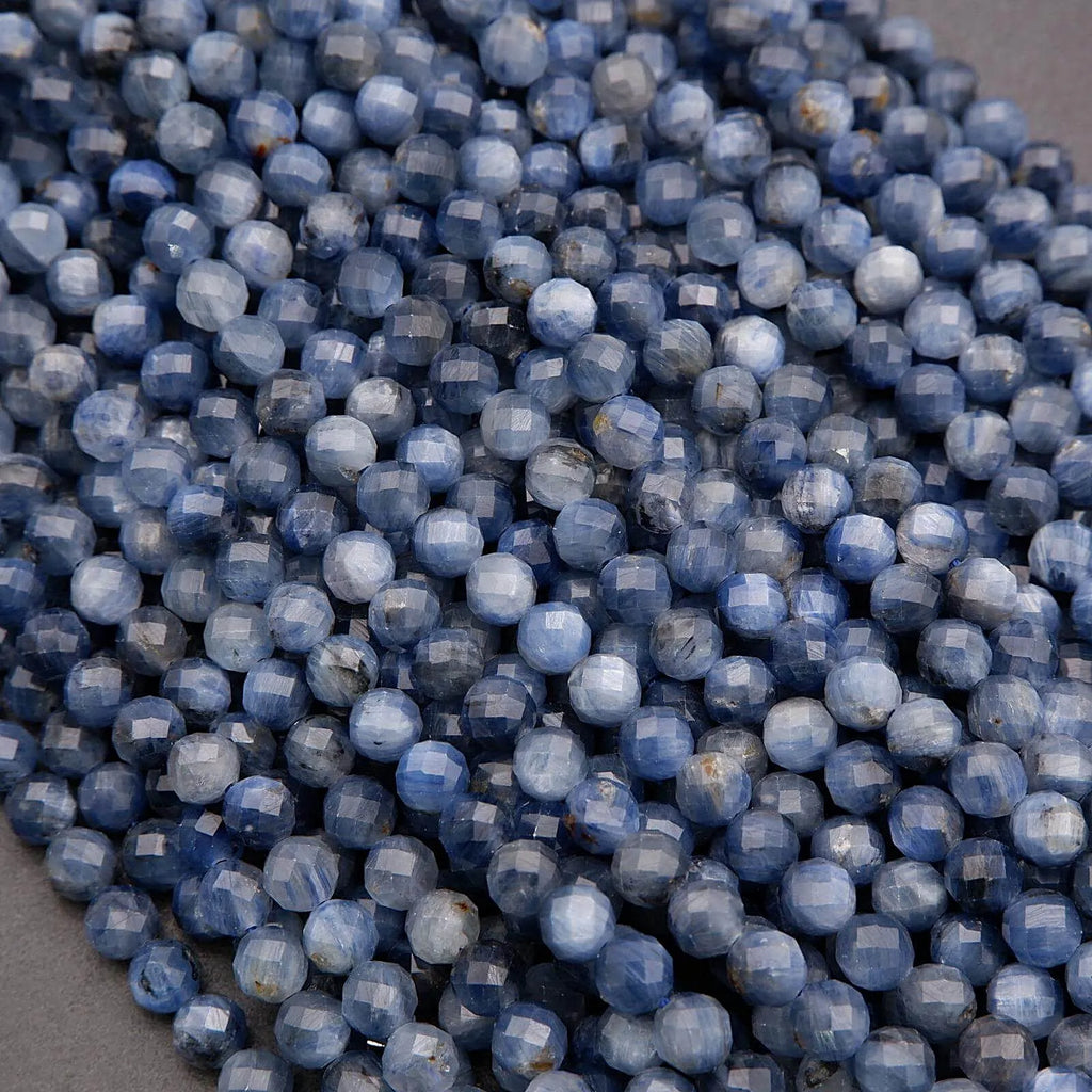 Close-up of blue faceted beads on a gray surface