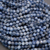 Close-up of blue faceted beads on a gray background