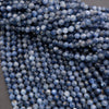 Close-up of blue faceted beads on a gray background