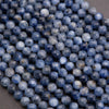 Close-up of blue faceted beads on a dark surface